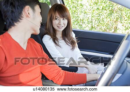Stock Photography - Young couple in a car. Fotosearch