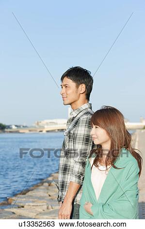 Stock Image - Young couple looking away, Hyogo Prefecture, Honshu, Japan. Fotosearch