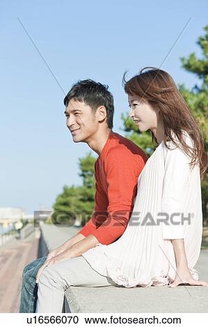 Stock Image - Young couple looking away, Hyogo Prefecture, Honshu, Japan. Fotosearch