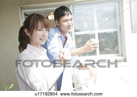 Young couple looking out the balcony View Large Photo Image Picture - Young couple looking out the balcony. Fotosearch
