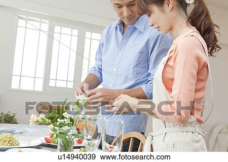 Young couple serving salad View Large Photo Image Stock Photo - Young couple serving salad. Fotosearch