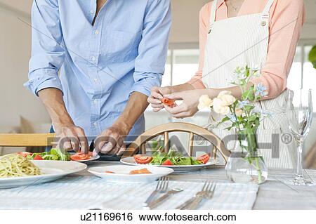 Young couple serving salad View Large Photo Image Stock Photograph - Young couple serving salad. Fotosearch