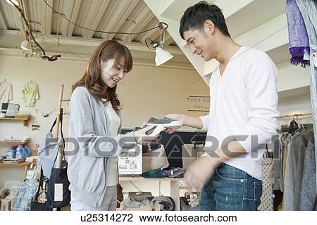 Stock Image - Young couple shopping. Fotosearch