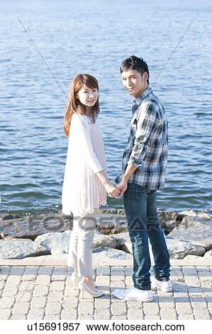 Young couple standing by the river, Hyogo Prefecture, Honshu, Japan View Large Photo Image Stock Photo - Young couple standing by the river, Hyogo Prefecture, Honshu, Japan. Fotosearch