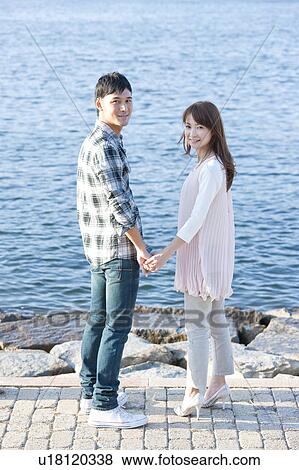 Young couple standing by the river, Hyogo Prefecture, Honshu, Japan View Large Photo Image Stock Photo - Young couple standing by the river, Hyogo Prefecture, Honshu, Japan. Fotosearch