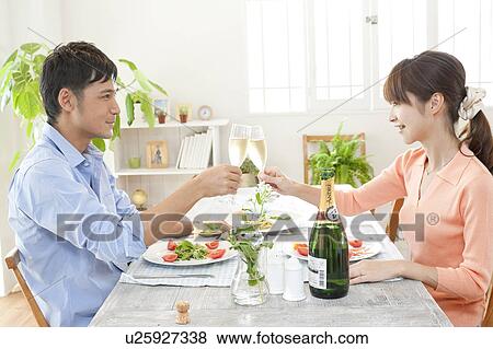 Stock Photo - Young couple toasting. Fotosearch