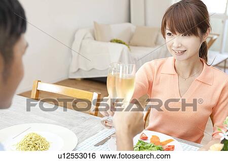 Stock Photograph - Young couple toasting. Fotosearch