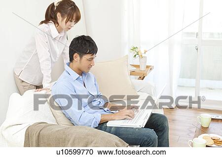 Young couple using laptop View Large Photo Image Stock Image - Young couple using laptop. Fotosearch