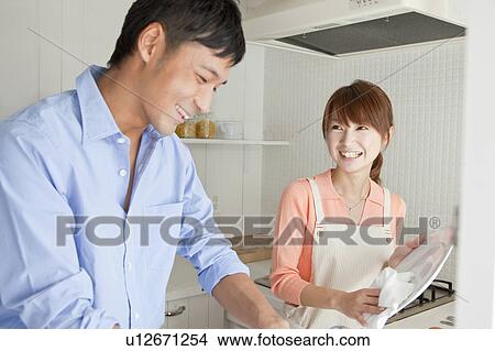 Young couple washing dishes View Large Photo Image Picture - Young couple washing dishes. Fotosearch