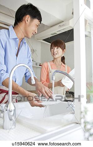 Picture - Young couple washing dishes. Fotosearch