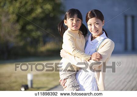 Stock Image - Young Female Nurse and Girl. Fotosearch