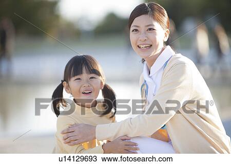 Stock Image - Young Female Nurse and Girl. Fotosearch