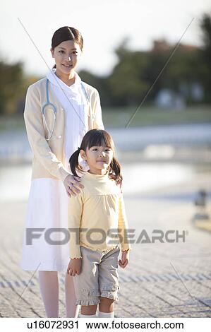 Stock Image - Young Female Nurse and Girl. Fotosearch
