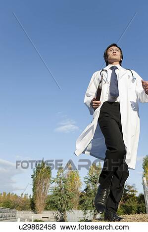 Stock Photo - Young Male Doctor Running. Fotosearch