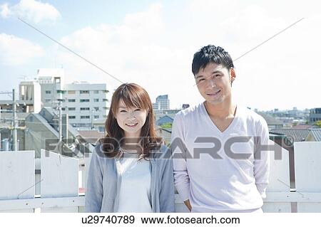 Young Woman and Man in Balcony View Large Photo Image Stock Photo - Young Woman and Man in Balcony. Fotosearch