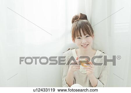 Stock Photo - Young Woman Having Tea. Fotosearch
