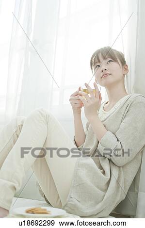 Stock Photo - Young Woman Having Tea. Fotosearch