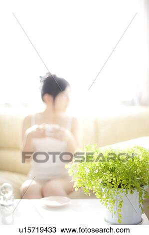 Young woman holding a coffee cup View Large Photo Image Stock Image - Young woman holding a coffee cup. Fotosearch