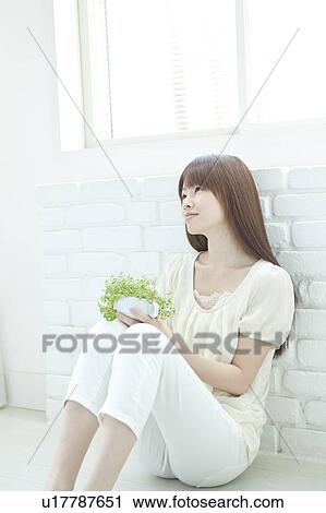 Young woman Holding Houseplant View Large Photo Image Stock Image - Young woman Holding Houseplant. Fotosearch