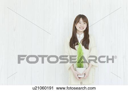 Young woman Holding Houseplant View Large Photo Image Stock Image - Young woman Holding Houseplant. Fotosearch