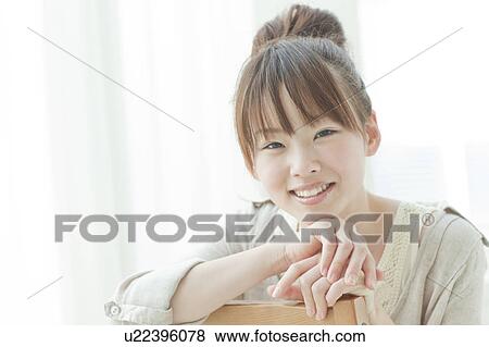Stock Photo - Young Woman Looking At Camera. Fotosearch