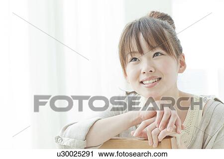 Stock Image - Young Woman Looking Up. Fotosearch