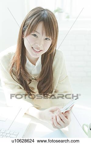Young woman mailing at desk View Large Photo Image Picture - Young woman mailing at desk. Fotosearch