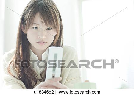 Young woman mailing at desk View Large Photo Image Stock Image - Young woman mailing at desk. Fotosearch