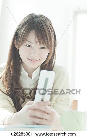 Young woman mailing at desk View Large Photo Image Stock Image - Young woman mailing at desk. Fotosearch