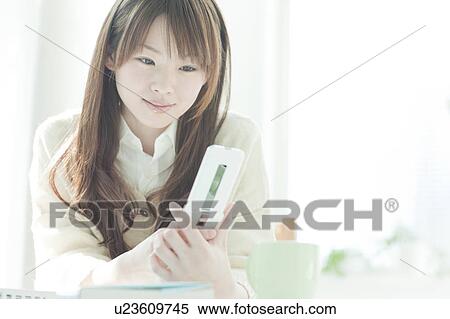 Young woman mailing at desk View Large Photo Image Stock Photography - Young woman mailing at desk. Fotosearch