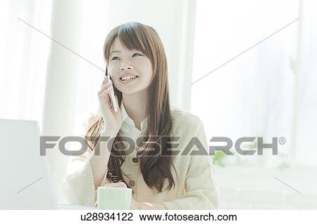 Stock Image - Young woman on the phone. Fotosearch