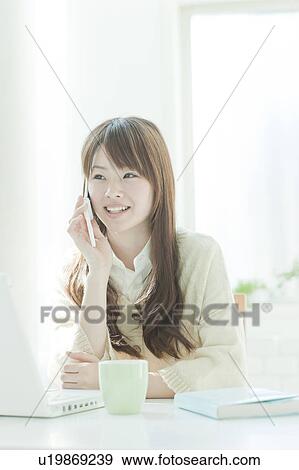 Young woman on the phone View Large Photo Image Stock Photo - Young woman on the phone. Fotosearch