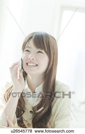 Stock Photo - Young woman on the phone. Fotosearch