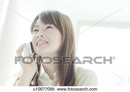Stock Photography - Young woman on the phone. Fotosearch