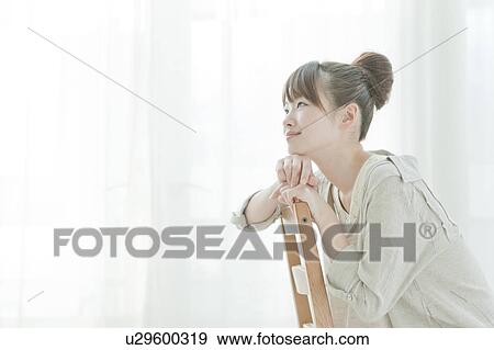 Young Woman Sitting on Chair View Large Photo Image Stock Photo - Young Woman Sitting on Chair. Fotosearch