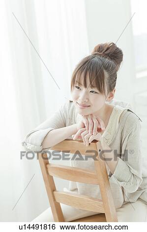 Young Woman Sitting on Chair View Large Photo Image Stock Photograph - Young Woman Sitting on Chair. Fotosearch