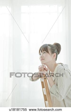 Stock Photography - Young Woman Sitting on Chair. Fotosearch