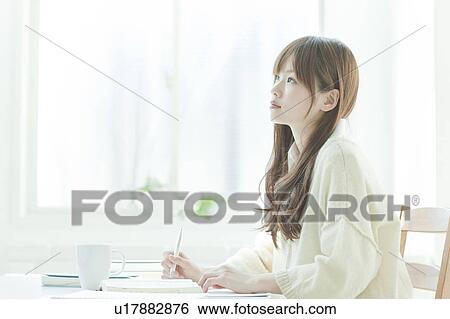 Young woman studying at desk View Large Photo Image Stock Photograph - Young woman studying at desk. Fotosearch