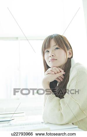 Young woman studying at desk View Large Photo Image Stock Photograph - Young woman studying at desk. Fotosearch
