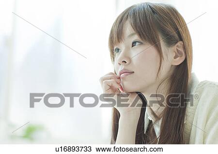 Stock Image - Young woman thinking. Fotosearch