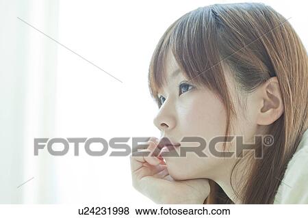 Stock Photo - Young woman thinking. Fotosearch