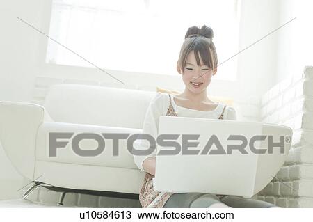 Stock Image - Young Woman Using Laptop. Fotosearch