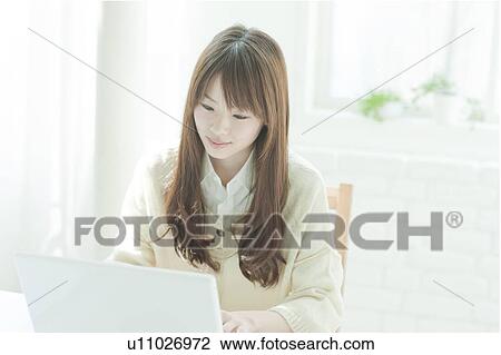 Young woman using laptop View Large Photo Image Stock Image - Young woman using laptop. Fotosearch