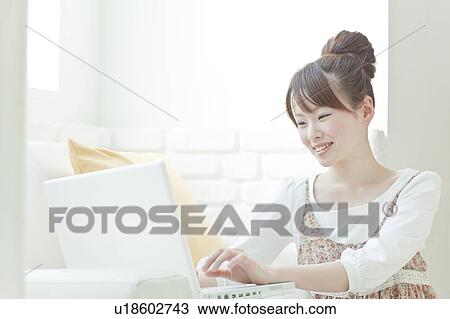 Stock Image - Young Woman Using Laptop. Fotosearch