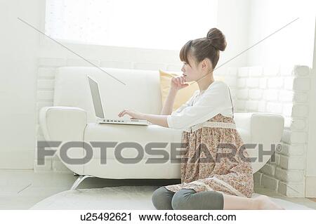 Stock Image - Young Woman Using Laptop. Fotosearch