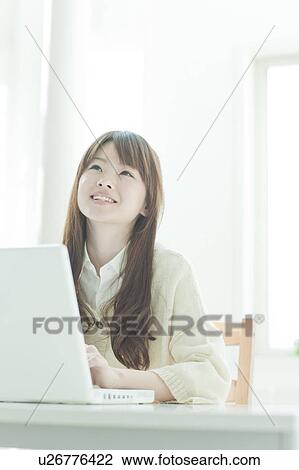 Young woman using laptop View Large Photo Image Stock Image - Young woman using laptop. Fotosearch
