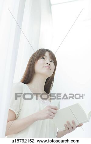 Stock Image - Young Woman with Book. Fotosearch
