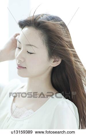 Young woman with hair fluttering View Large Photo Image Stock Photo - Young woman with hair fluttering. Fotosearch