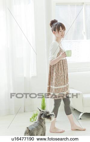 Stock Image - Young Woman with Miniature Schnauzer. Fotosearch
