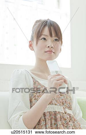 Stock Image - Young Woman with Mobile Phone. Fotosearch